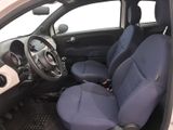 the interior of a small car with blue seats and a steering wheel