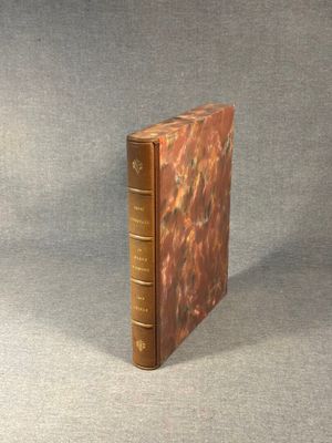 an old book sitting on top of a table next to a gray surface