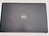 the dell laptop is sitting on a table with a white background