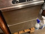 an image of a dishwasher with a bottle of water next to it