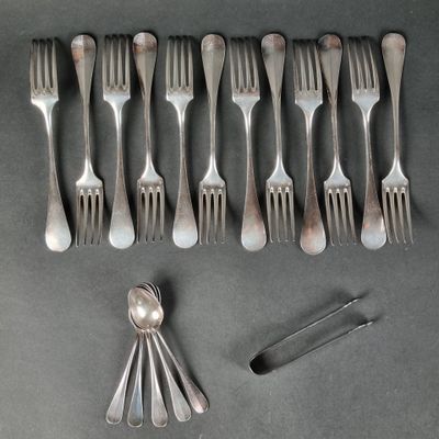 a lot of forks and spoons that are on the table