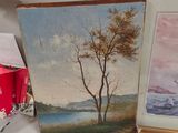 three paintings on a table with a vase and a vase