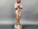 an old statue of a woman holding a baby in her arms