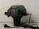 a close up of a green and black blower on a white surface