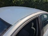 a silver car parked on the side of the road