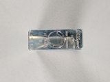 a piece of silver that is on a white surface