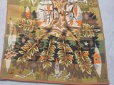 a rug with a picture of a tree and birds on it