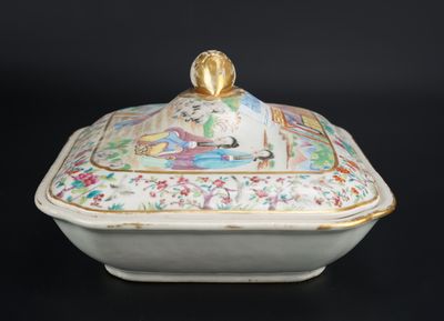 a white and gold covered dish with a bird on it