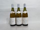 three bottles of wine sitting on top of a table next to each other