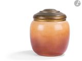 a small jar with a lid on a white surface