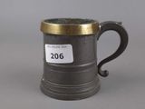 a close up of a metal mug on a gray surface