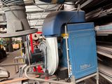 a blue machine that is sitting in a warehouse