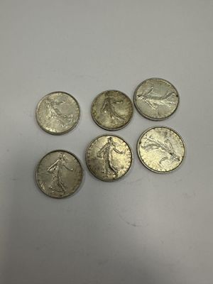 a close up of a bunch of coins sitting on top of a table