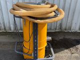 a yellow machine with a hose on a cart