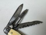 a small knife with a blade attached to it on a table