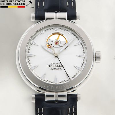 a close up of a watch with a white dial