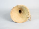 a small vase that is sitting on a white surface