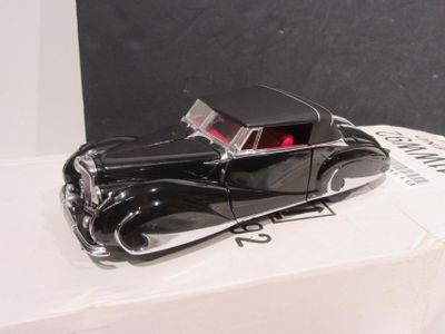 a black toy car sitting on top of a white box