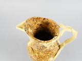 a small vase that has a handle on it