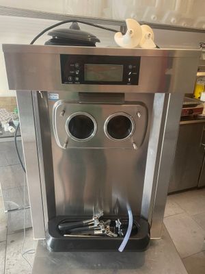 a stainless steel water dispenser in the middle of a kitchen