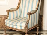 an image of a blue and white striped chair sitting on a black and white checkered floor