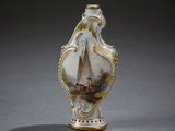 a small vase with a painting on it sitting on a table