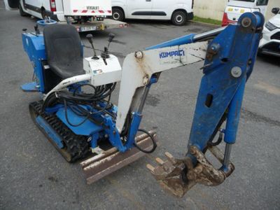 an image of a small blue and white machine in a parking lot