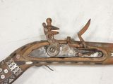 an old gun with a man riding on it