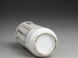 a white bottle that has a small amount of paint on it