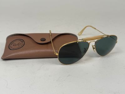 a pair of sunglasses sitting on top of a brown case