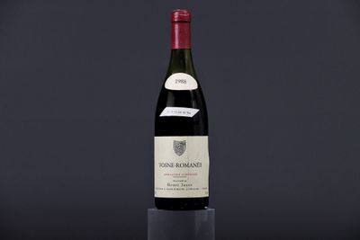 a bottle of wine sitting on top of a wooden table
