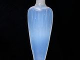 a glass bottle with a blue liquid inside of it