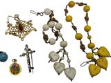 a lot of jewelry that is laying out on a white surface
