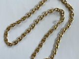 a close up of a gold chain on a white surface