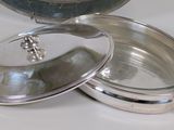 a silver container with a lid sitting on a table