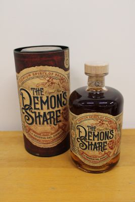 a bottle of liquor sitting on a table next to a canister