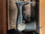 an old sewing machine sitting in a wooden box