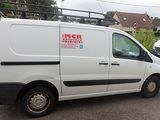 a white van that is parked in a parking lot