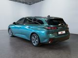 the rear end of a blue car in a room with white walls