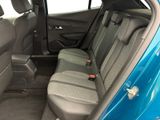 the back seats of a blue car are empty in the car
