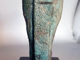 statue of a bird on a wooden base on a table