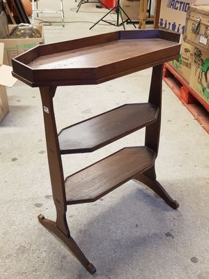une table sur laquelle se trouve une étagère, dans une pièce