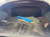 a blue umbrella sitting in the back of a pickup truck
