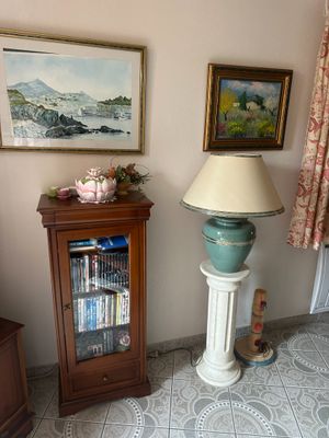 une lampe dans un coin de la pièce, près d'une bibliothèque