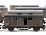 four train cars that are lined up on the tracks