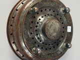 a metal object that is hanging on the wall