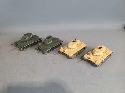 several toy tanks are lined up in a row on the floor