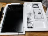 a laptop computer sitting in a white box on a table