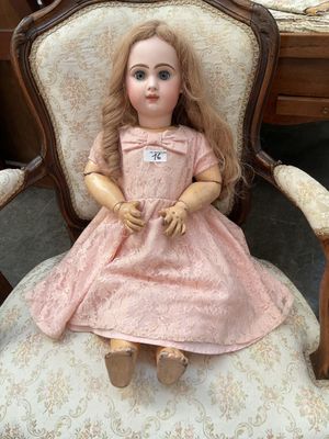 a doll that is sitting on a chair in a room