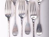 six forks and six spoons on a white surface